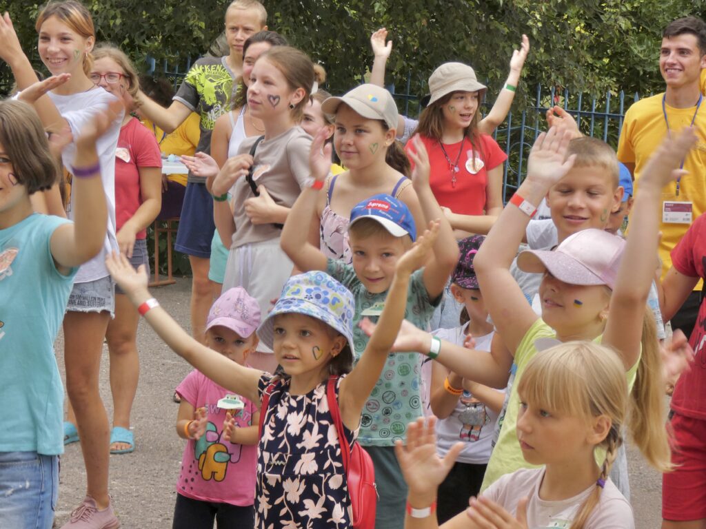 kids being cheered up in a deoccupied village