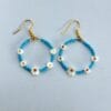 Handmade hoop earrings with small daisies