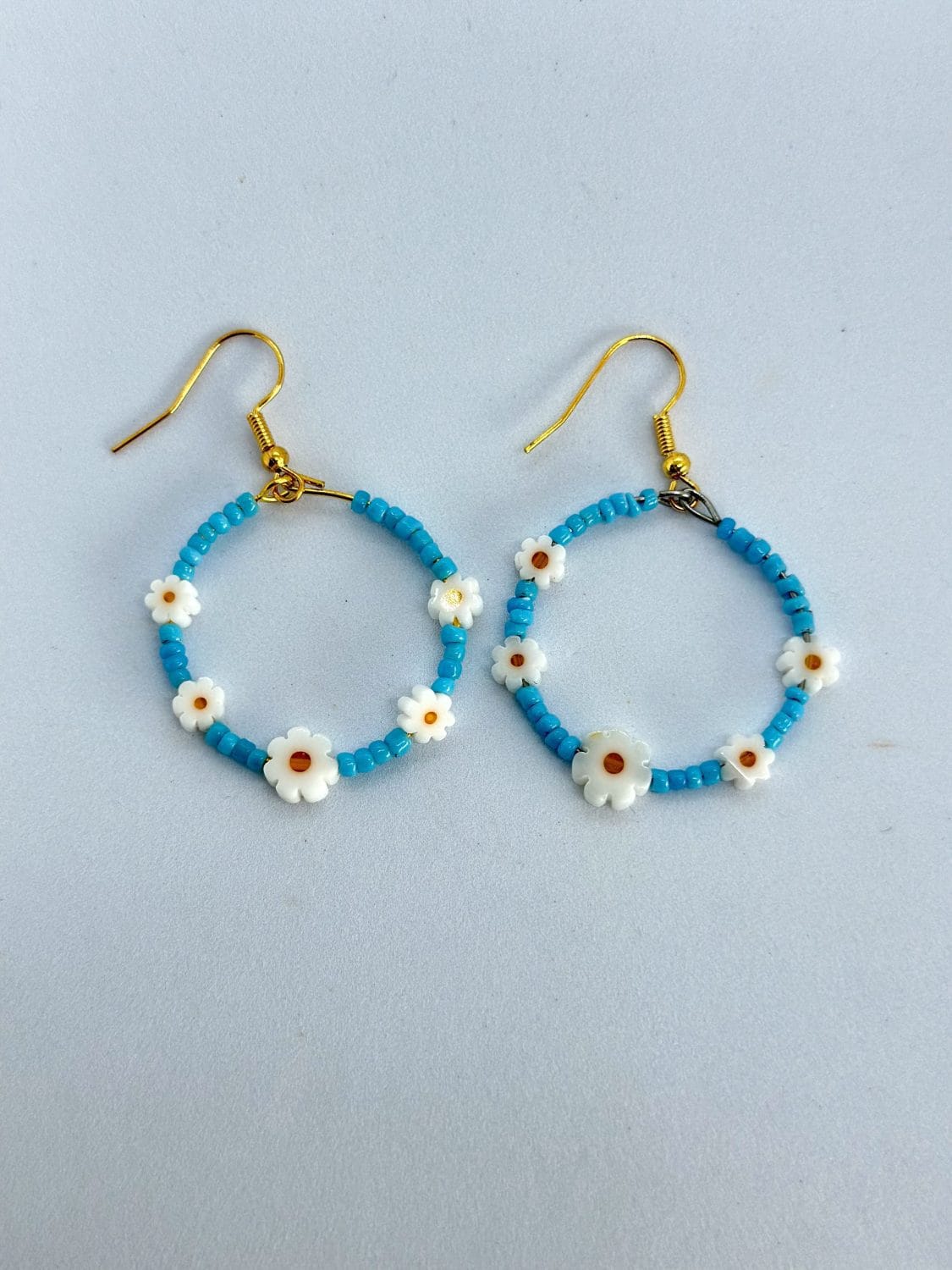 Handmade hoop earrings with small daisies