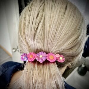 Pink hair clip with flowers on the hair