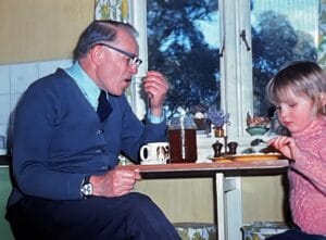 a man and girl sitting at a table eating
