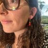 lady modelling earrings with Red Sandalwood beads