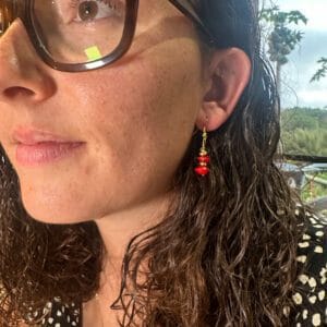 lady modelling earrings with Red Sandalwood beads