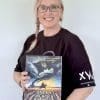 Lara with book a woman holding a book under black banners