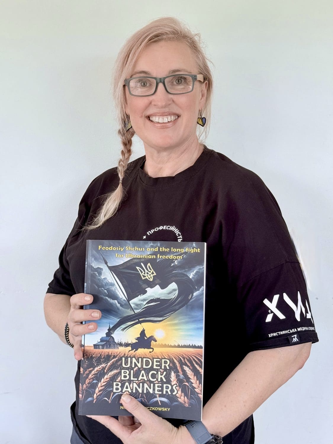 Lara with book a woman holding a book under black banners