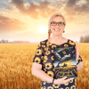 lara book ukr field a woman in a wheat field holding a copy of under black banners book