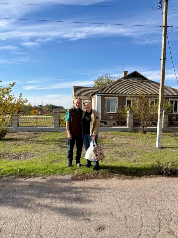 img_4651 A man and woman standing in front of a building