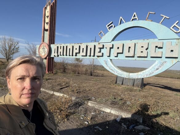 img_4681 A woman in front of a sign for Dnipropetrovsk oblast