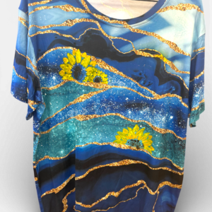 Blue patterned blouse with golden wavy lines and yellow sunflowers on a gradient blue background.