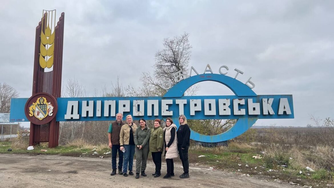 frontline medicine a clinic team poses in front of a sign in Ukraine